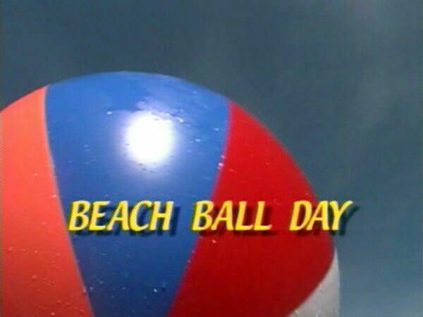 Nudists on a beach play a huge ball Nudists on a beach play a huge ball