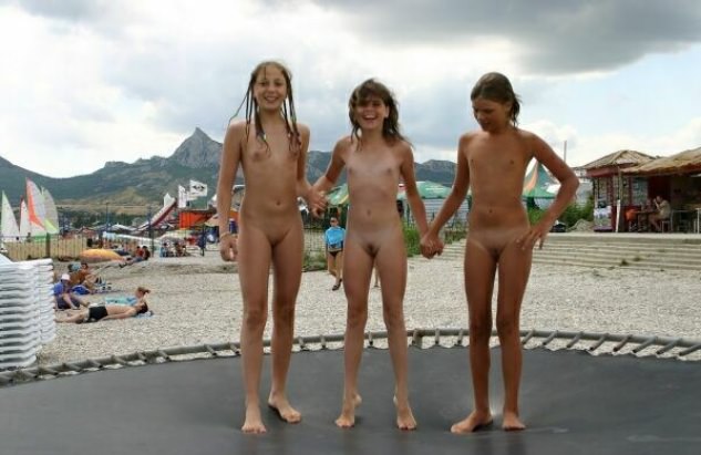 Nudists of the girl play on a beach Nudists of the girl play on a beach