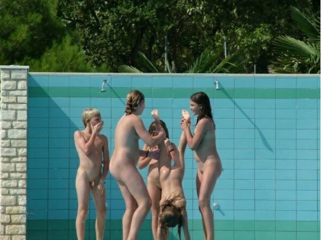 Nudists wash in a summer shower Nudists wash in a summer shower
